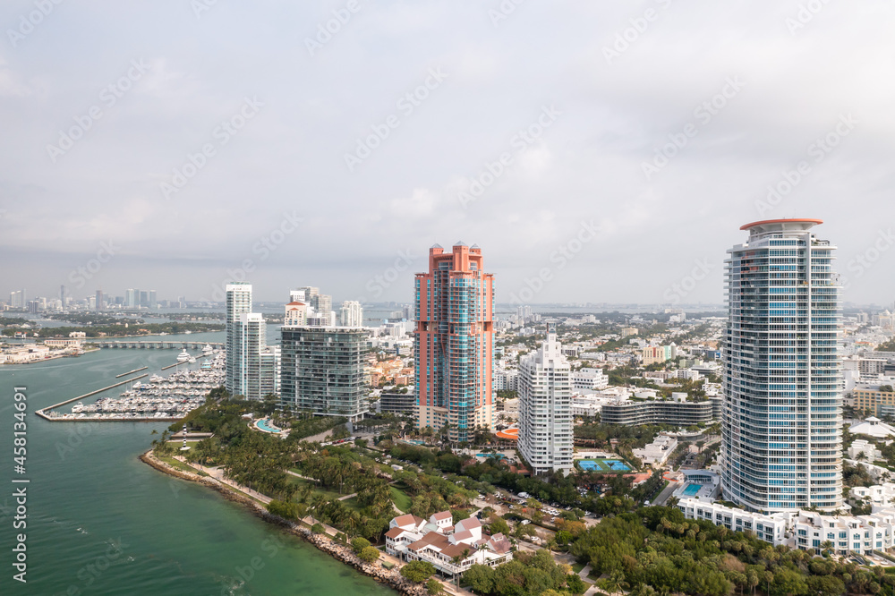 Beautiful aerial view overlooking South Pointe Park and high-rise condominiums on Miami Beach with Government Cut and Meloy Channel Marina below.