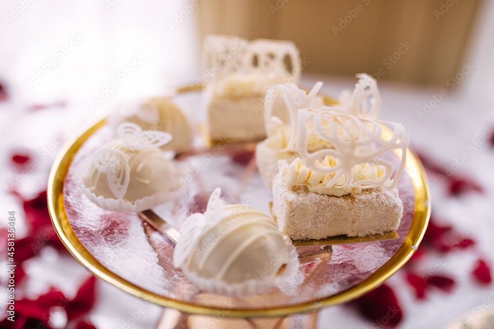 Dessert table for a party. Candy bar with lots of sweets with white cream at the feast. Dessert table for a party. Candy bar with lots of sweets with white cream at the feast.
