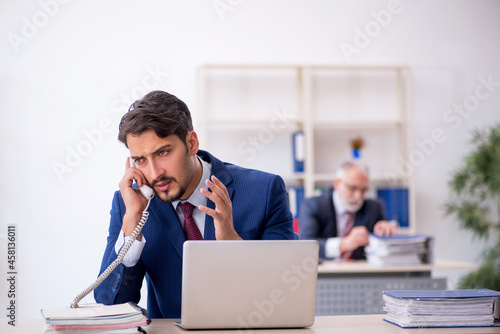 Two male colleagues working in the office