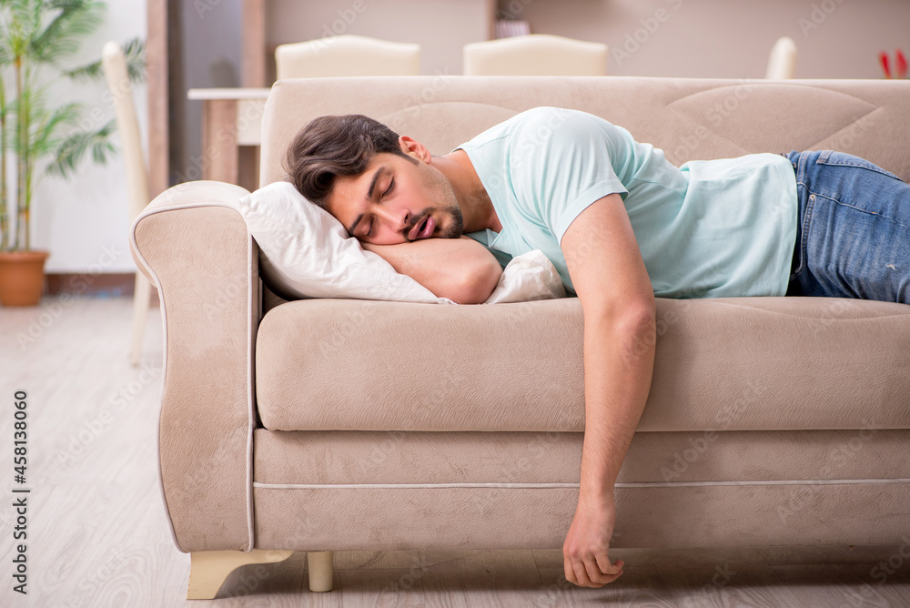 Young man student lying on the sofa at home Young man student lying on the sofa at home