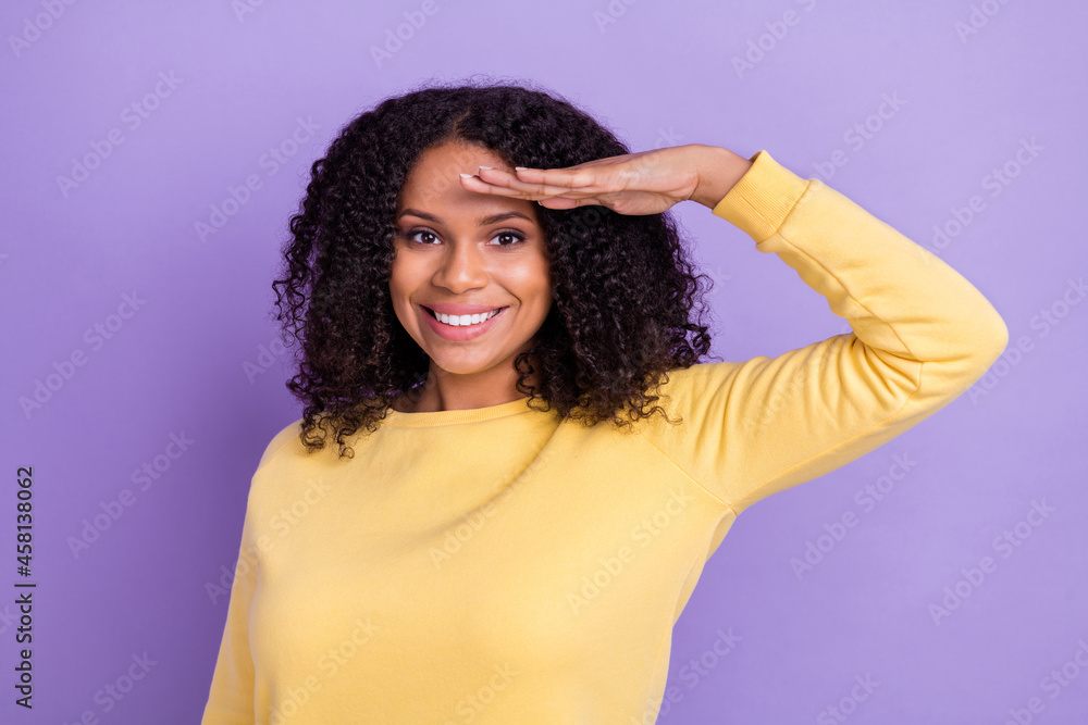 Photo of adorable friendly dark skin woman wear yellow sweater arm forehead looking far away isolated violet color background Photo of adorable friendly dark skin woman wear yellow sweater arm forehead looking far away isolated violet color background