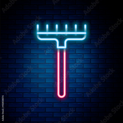 Glowing neon line Garden rake icon isolated on brick wall background. Tool for horticulture, agriculture, farming. Ground cultivator. Housekeeping equipment. Colorful outline concept. Vector
