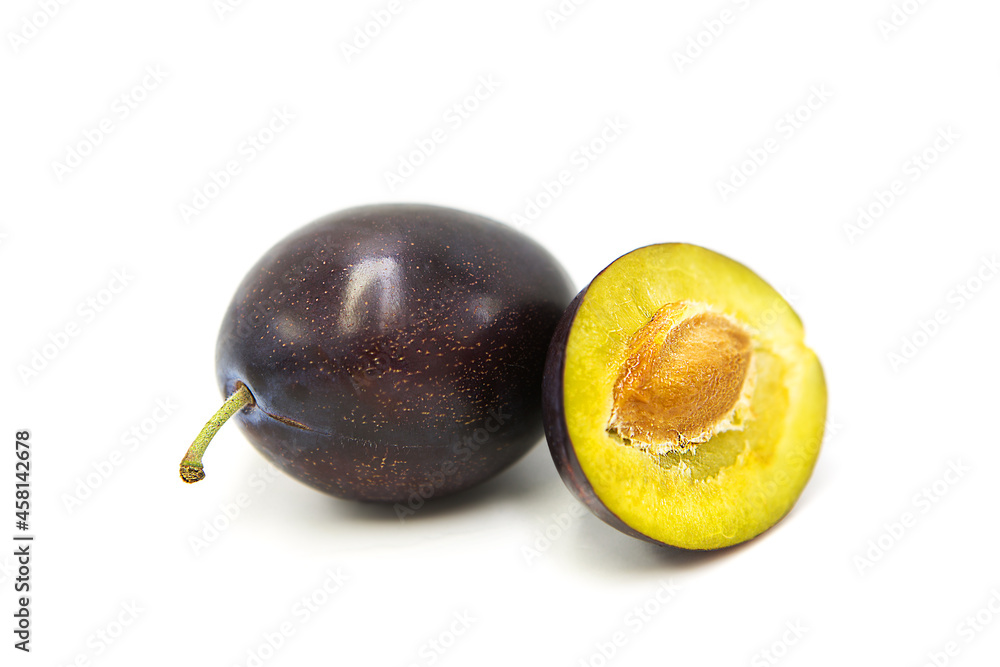 Ripe fresh organic plum whole and half isolated on white background. Ripe fresh organic plum whole and half isolated on white background.