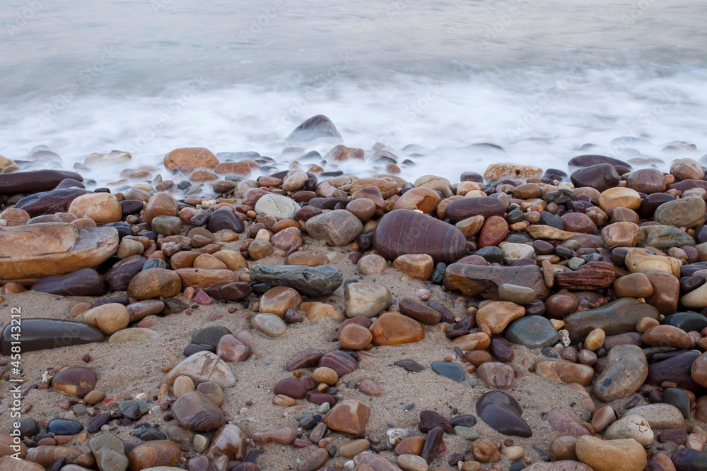 soft blue waves coming through colourful pebbles at the beach in Adelaide, South Australia soft blue waves coming through colourful pebbles at the beach in Adelaide, South Australia