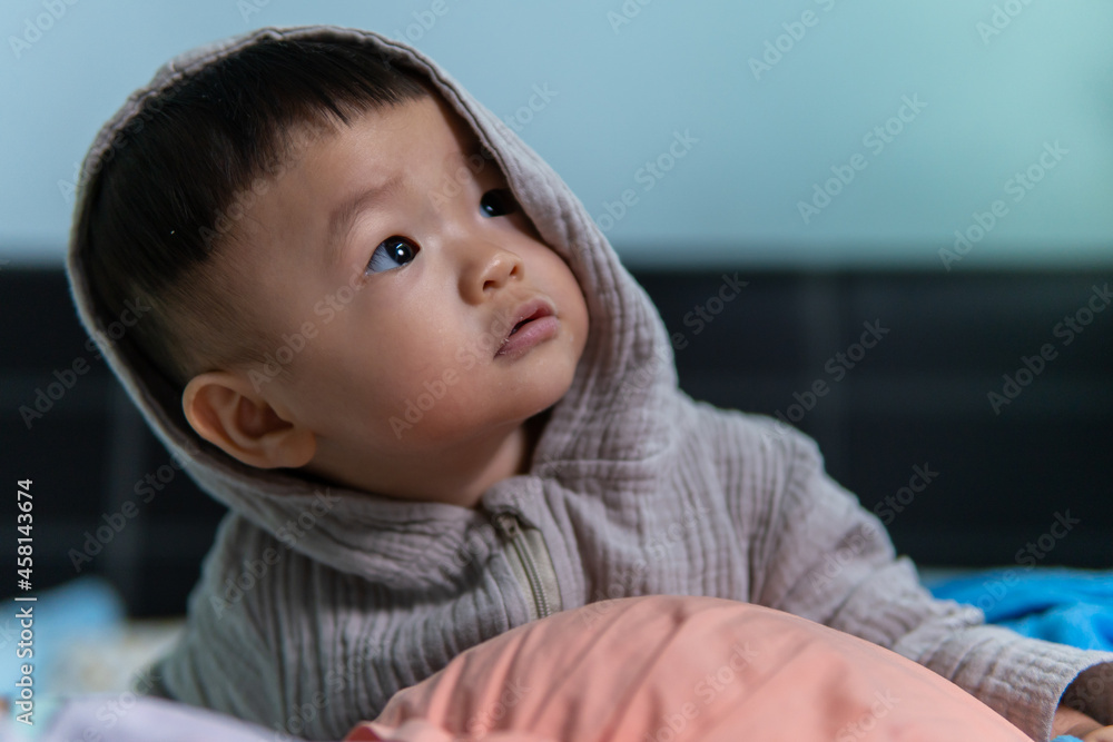 Portrait Adorable and happy 1 years old Chinese baby boy child relaxing in bed Portrait Adorable and happy 1 years old Chinese baby boy child relaxing in bed