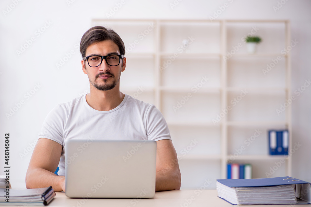 Young male employee freelancer sitting in the office Young male employee freelancer sitting in the office
