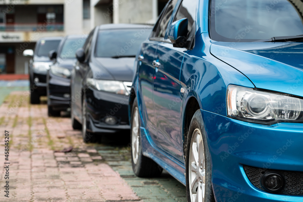 Blue Car parked neatly inside an outdoor parking lot. Blue Car parked neatly inside an outdoor parking lot.