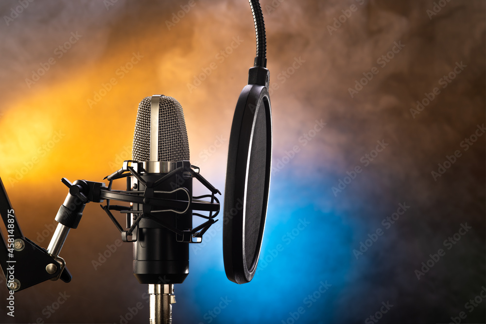 Studio professional microphone and pop filter on yellow-blue smoky  background. There are no people in the photo. Close-up. Vocals, spoken  genre, instrumental music, purity of sound, radio, television. Stock 写真 |  Adobe