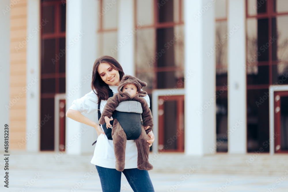 Cheerful Mom Walking her Cute Infant in Baby Carrier