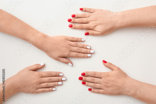 Many female hands with beautiful manicure on white background  closeup