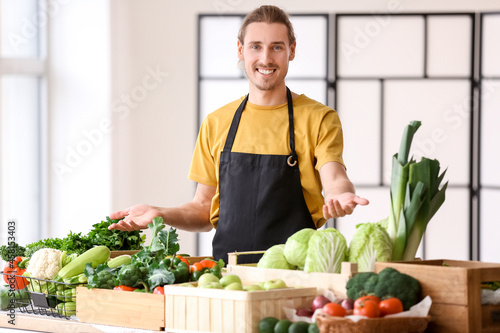 Male seller with fresh vege...