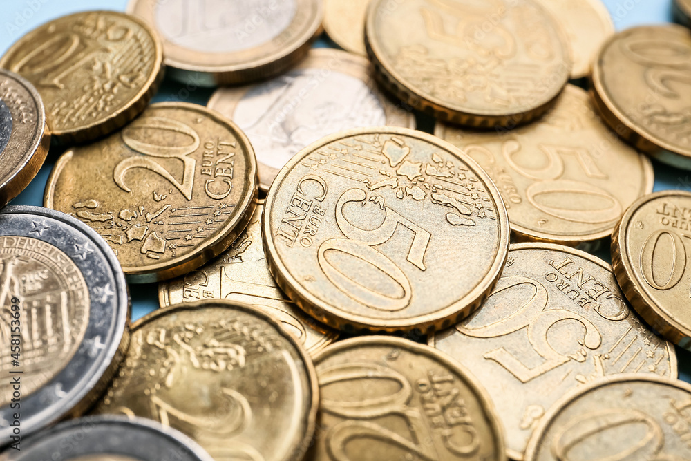 Heap of coins on color background, closeup Heap of coins on color background, closeup