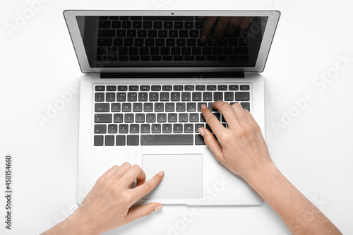 Woman working with laptop on white background