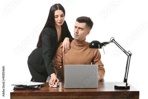 Beautiful young secretary seducing her boss on white background. Concept of harassment photo