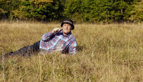 the senior man rests lying on a meadow in nature © mirza77