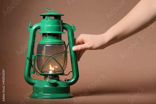 Female hand and retro lamp ...