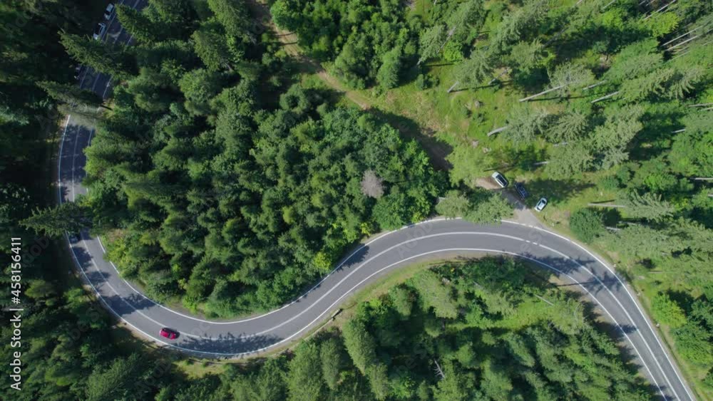 drone view of the winding mountain road in a green forest drone view of the winding mountain road in a green forest
