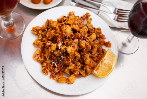 Breaded fried baby calamari with lemon, traditional spanish dish