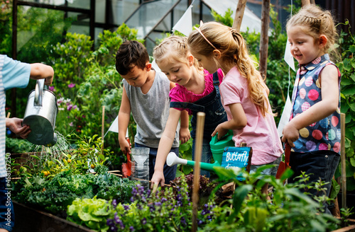Canvas Print Group of kindergarten kids learning gardening outdoors