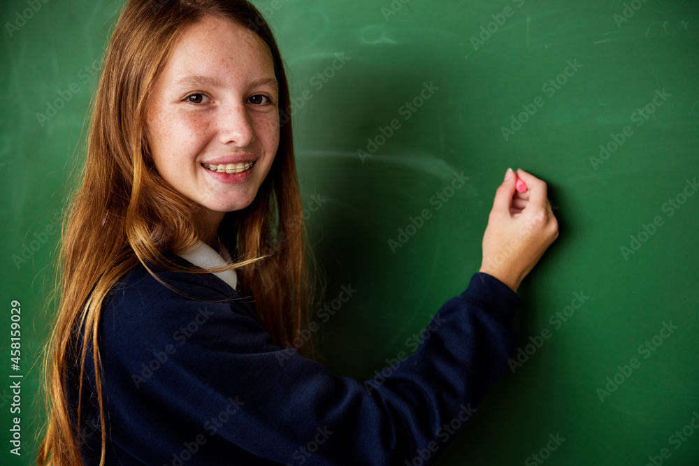 Female student writing on whiteboard Female student writing on whiteboard