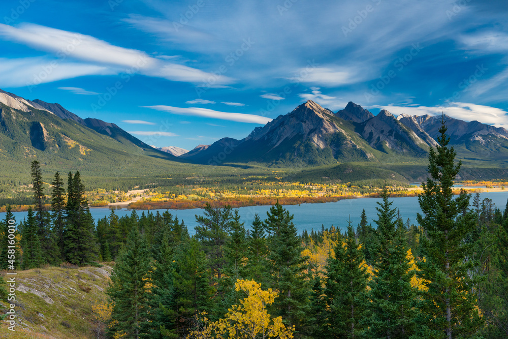 Beautiful autumn colors by the lake and mountain range in Alberta, Canada