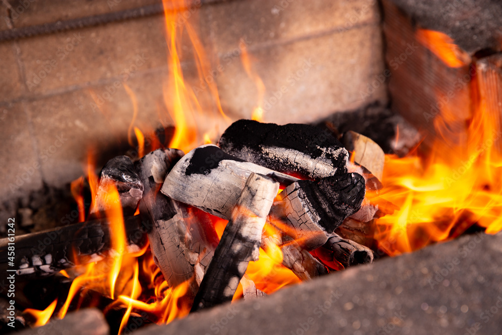 Firewood burning fire and hot orange flames Firewood burning fire and hot orange flames