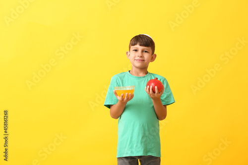 Little boy with pomegranate...