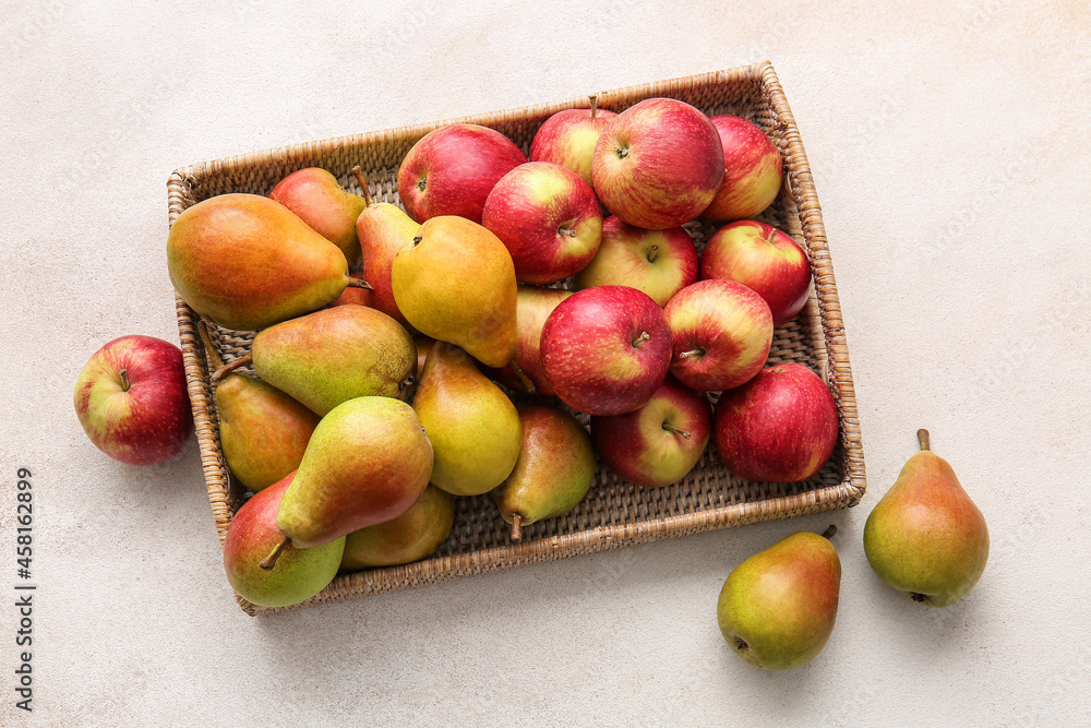 Tray with ripe pears and apples on light background Tray with ripe pears and apples on light background
