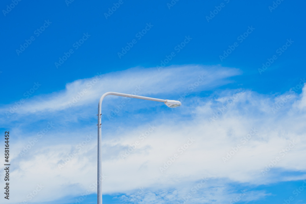 The street light pole stand against the bright blue sky background with copy space The street light pole stand against the bright blue sky background with copy space