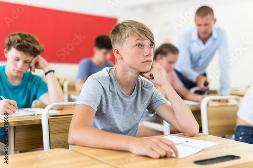 Portrait of attentive focused boy in school auditorium