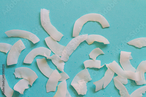 Background of dried coconut white chips on a blue background
