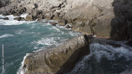 Footage. Water splashing. Pirate Bay Novy Svet Places. Mount Eagle is an ancient coral reef colonies. Sea water beats against rocks. Crimea. Novy Svet place.