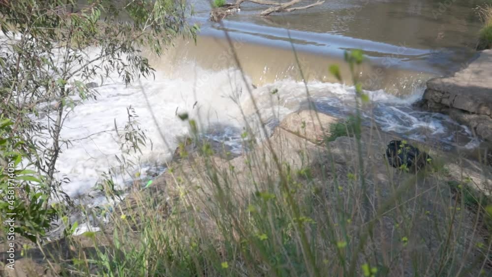 Waterfall flowing over rocky weir on river in Yarra Bend Park, Melbourne, Australia Waterfall flowing over rocky weir on river in Yarra Bend Park, Melbourne, Australia