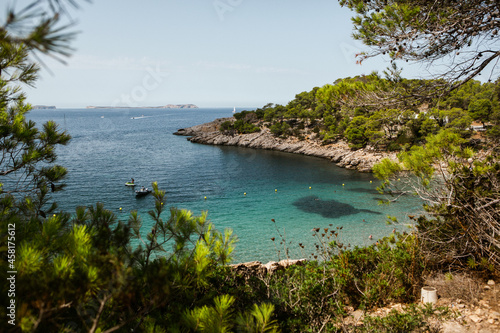 Beautiful beach with very clean and azure water on the mediterranean sea in the island of Ibiza, Spain