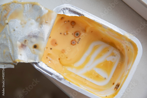 Spoiled cheese with mold and mildew. Violation of food storage conditions, shelf life, close-up