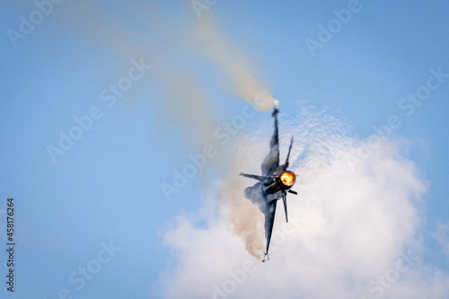 Fighter jet displaying during airshow with afterburner photo