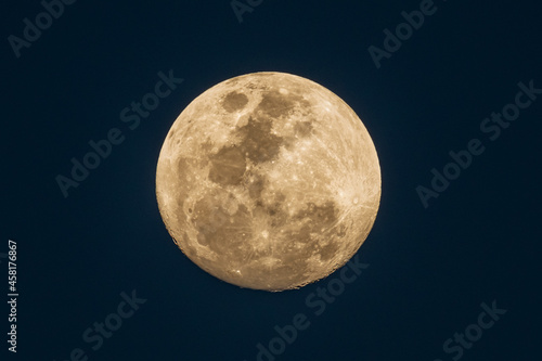 Ninety Eight Percent Full Moon in an early evening sky photo