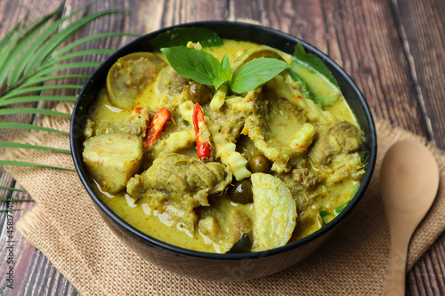 Thai green curry with beef served in bowl of the wood table - Thai food called Kang Keow Wan
