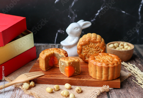 Moon cake - Chinese mooncake for Mid-autumn festival served on wood tray at close up view 