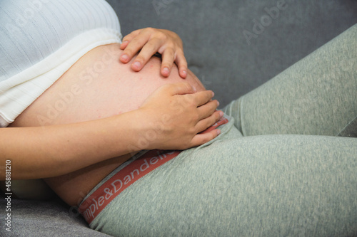 pregnant woman holding her stomach