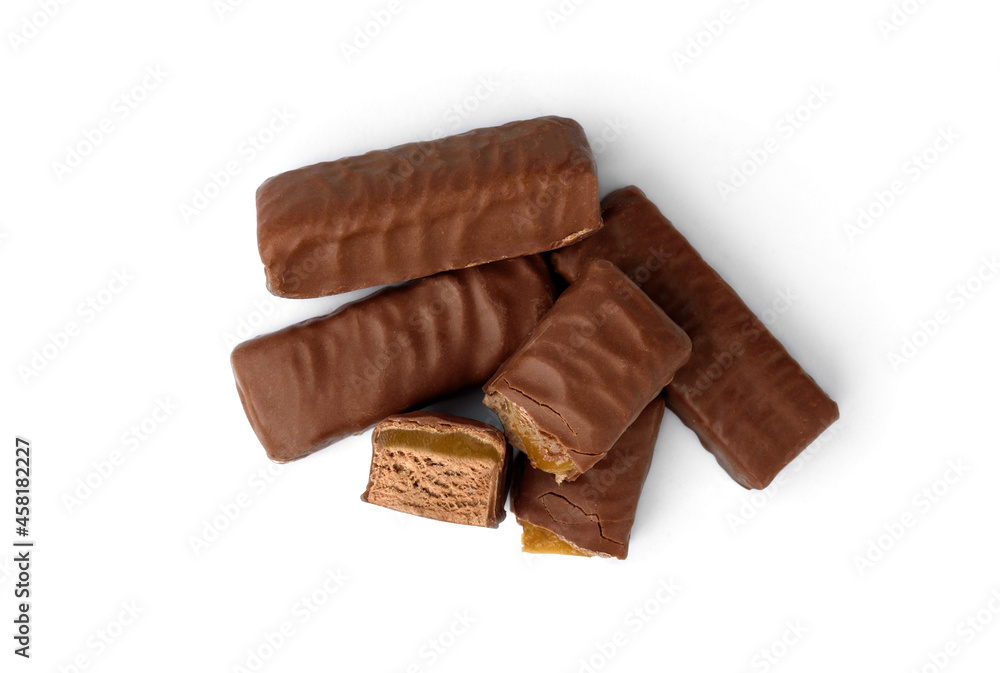 Pile of chocolate sweets with nougat, caramel and nuts isolated on white background. Pile of chocolate sweets with nougat, caramel and nuts isolated on white background.
