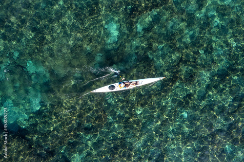 Single seat canoe rowing over a shallow lagoon, Aerial view. © STOCKSTUDIO