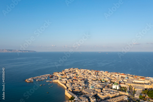 Acre old city houses and Mosque at sunrise, Aerial view.