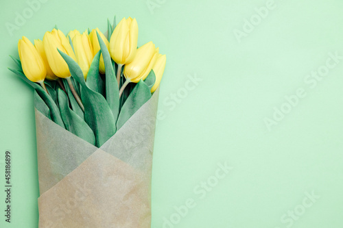 Yellow tulips on a green background. Spring flowers. Tulips from Holland. Sell tulips. Spring mood