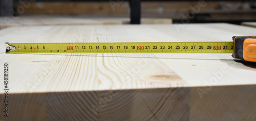 Measure tape on wooden board