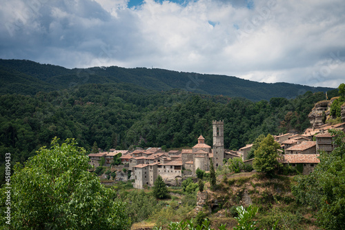 Landscape of the town of Rupit against the mountains on a cloudy day