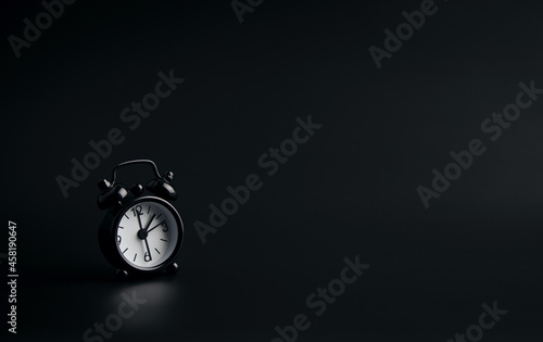 Clock on a black background. With copy space, design for vintage and business.