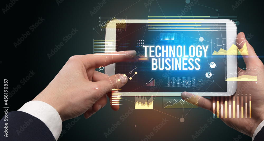 Close-up of hands holding tablet with business inscription Close-up of hands holding tablet with business inscription