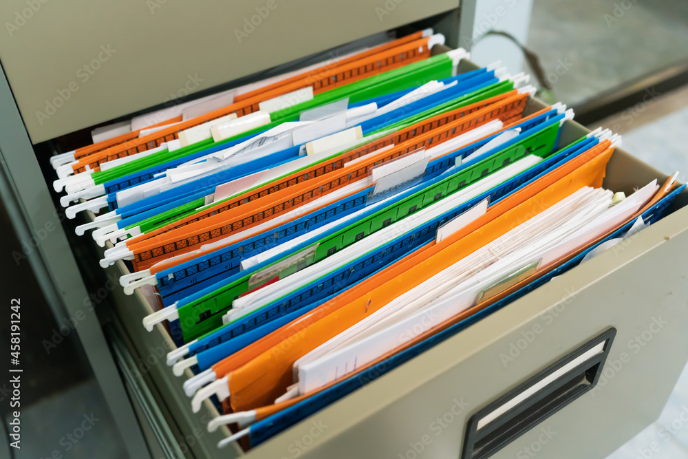 The colorful document files are hanging in drawer.