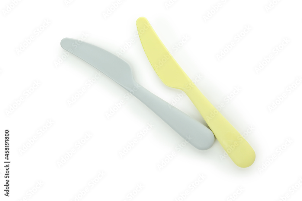 Plastic yellow and gray knives isolated on white background Plastic yellow and gray knives isolated on white background